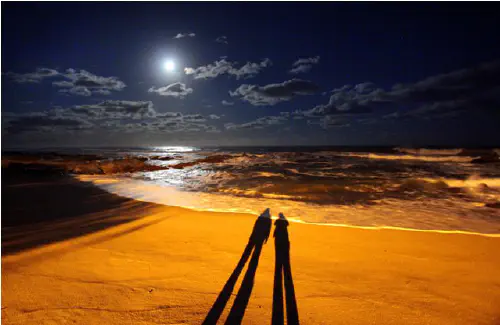 Shadows and full moon at the beach