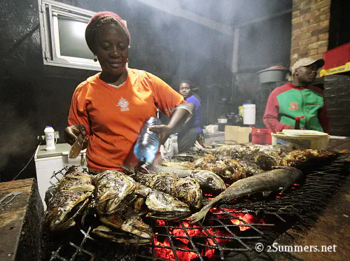 Lucy making fish in Yeoville
