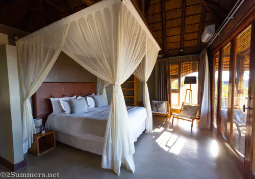 Bedroom in the deluxe suite at Mhondoro Safari Lodge