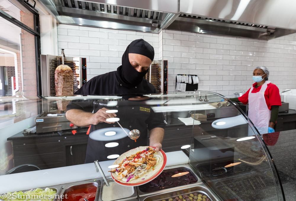 Muhammed from King Arabic Sandwich loading up shawarmas